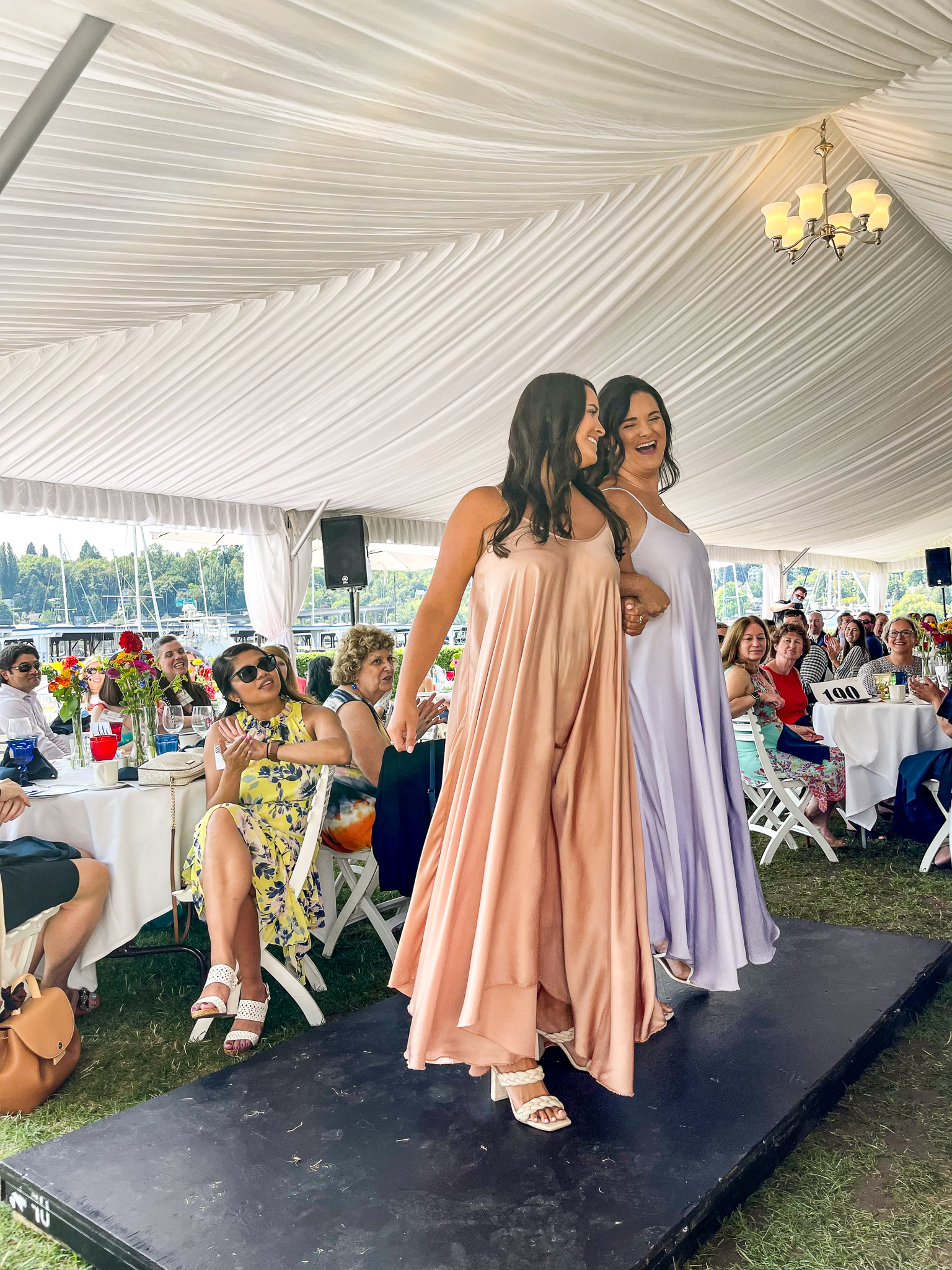 Sisters on stage in pink and purple dresses