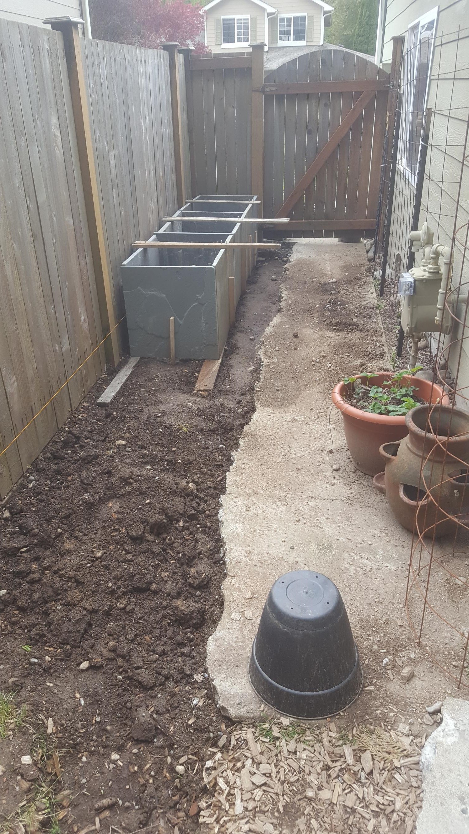 A demo of a sidewalk and raised garden beds